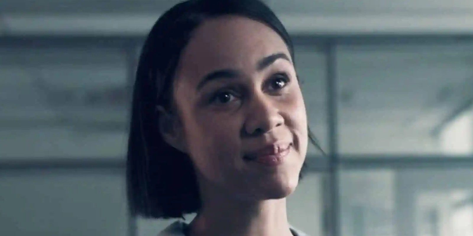 Zawe Ashton smiling as Oona in The Handmaid's Tale