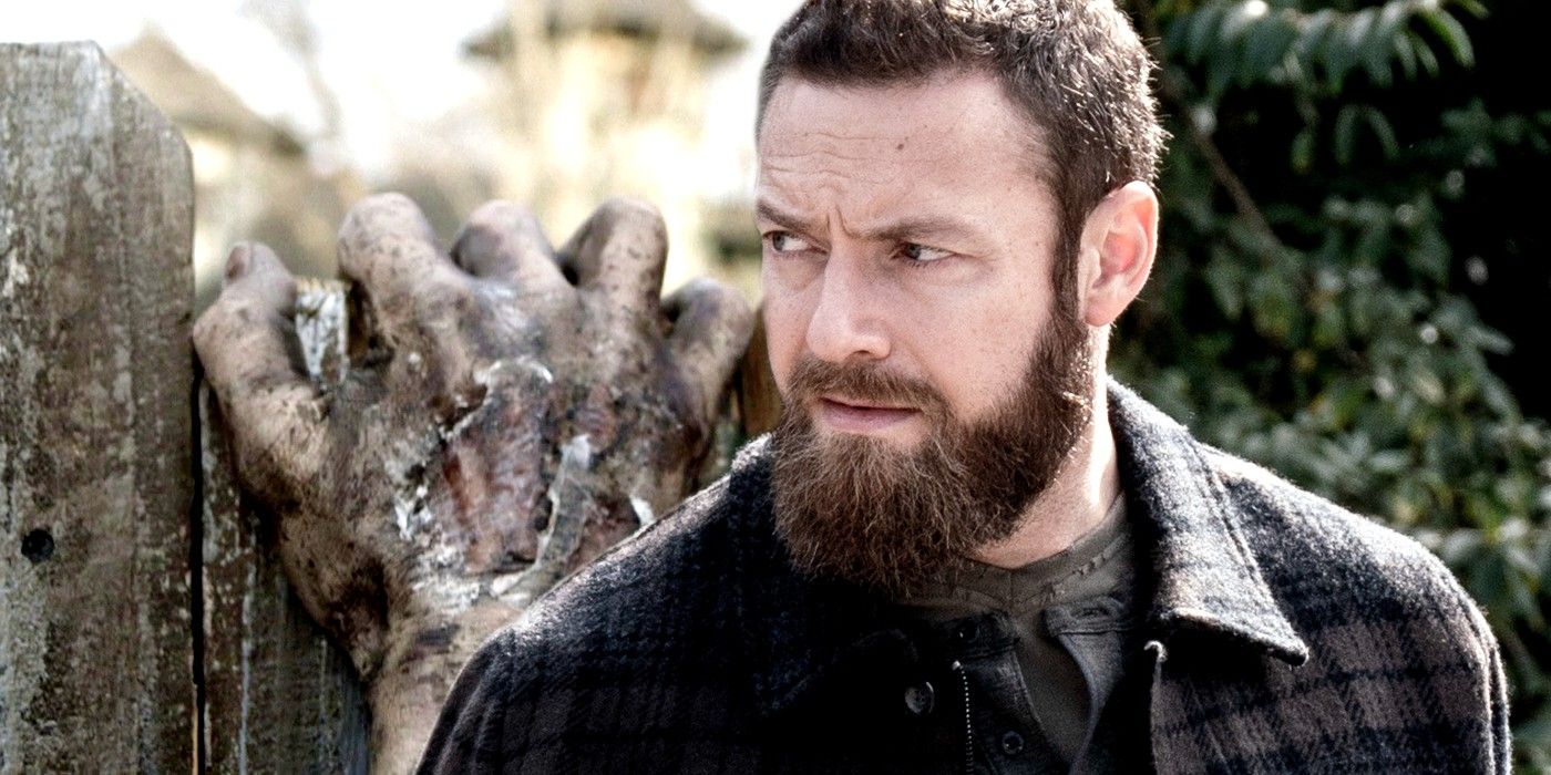 Zombie hand and Ross Marquand as Aaron in Walking Dead