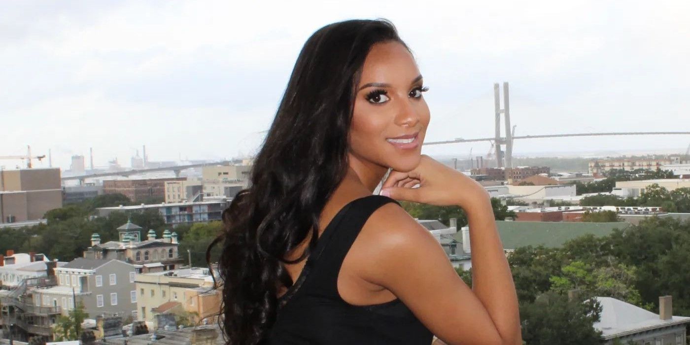 Chantel Everett from The Family Chantel posing on balcony in black dress 