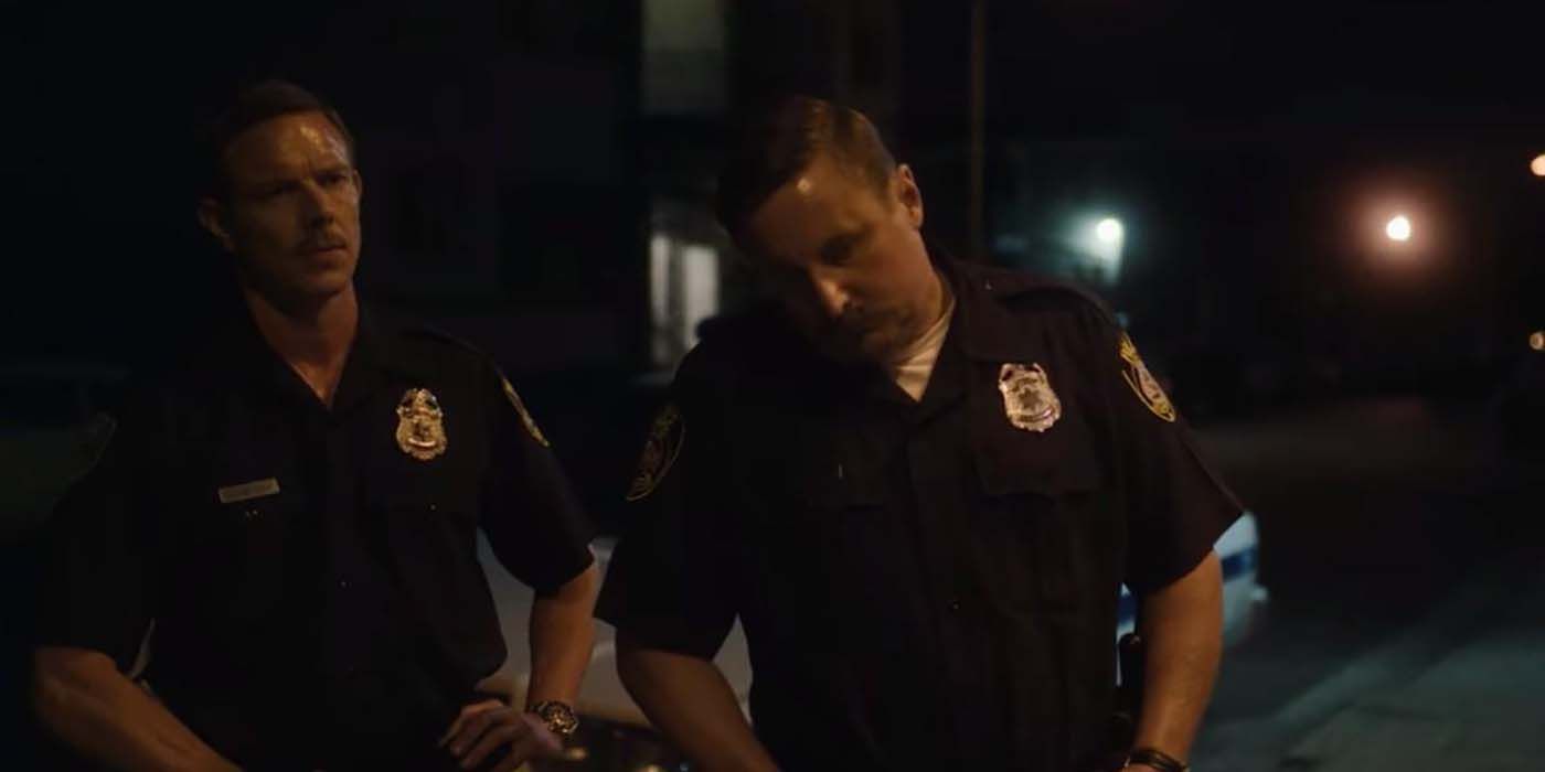 Two police officers outside in a scene from Monster: The Jeffrey Dahmer Story
