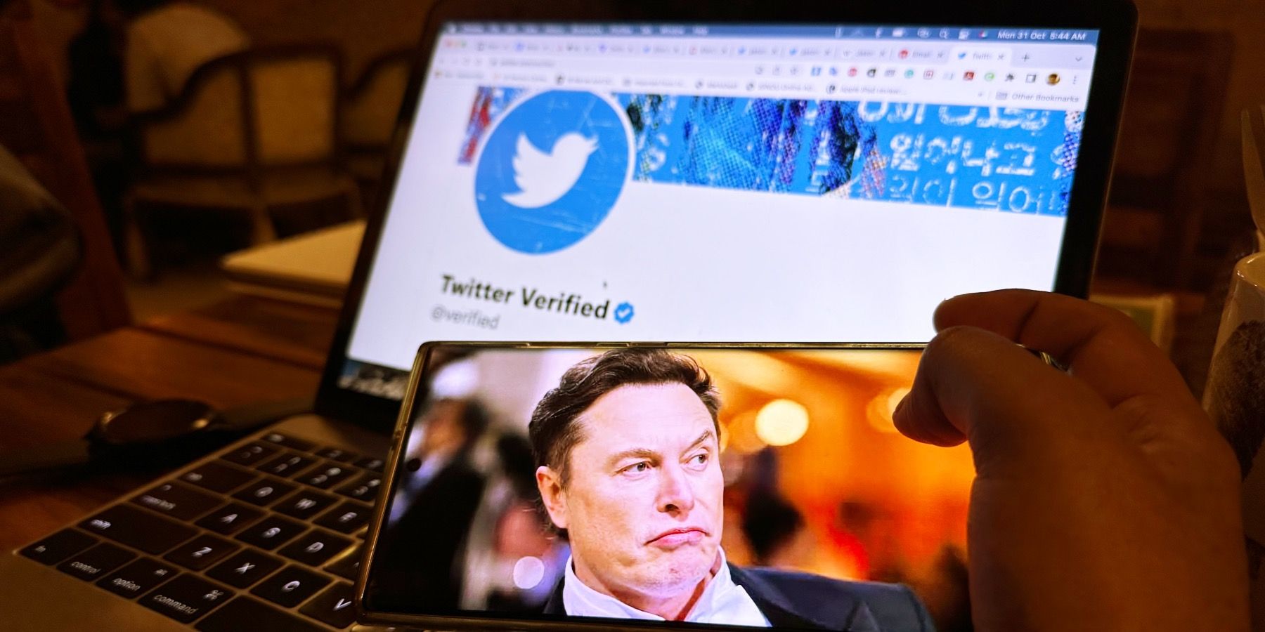 Musk against the backdrop of the official Twitter Verified account.