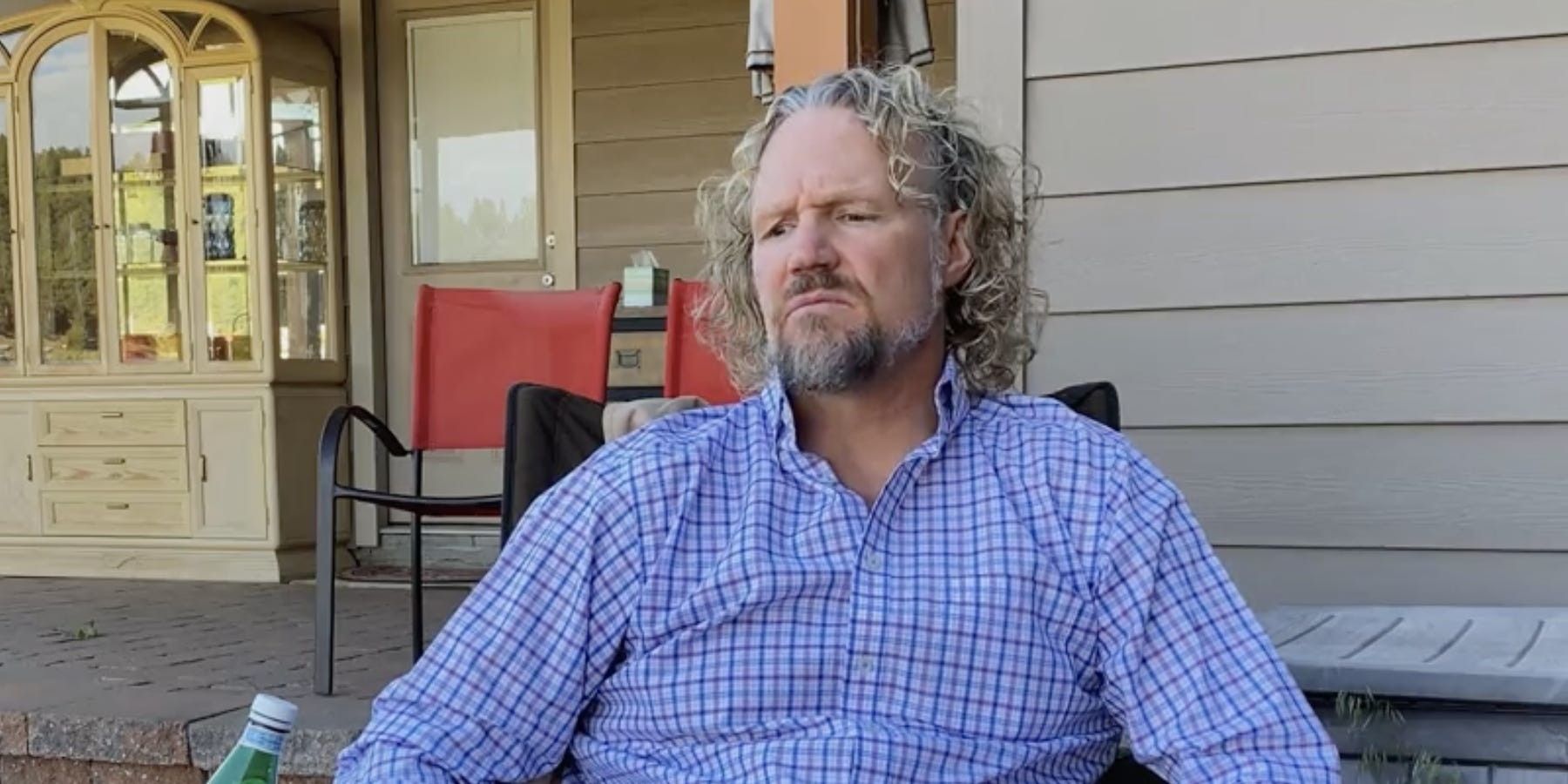 Kody Brown from Sister Wives wearing blue shirt on porch