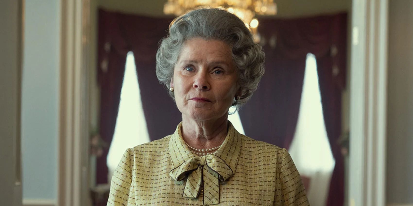 Imelda Staunton as Queen Elizabeth II looking intently In The Crown