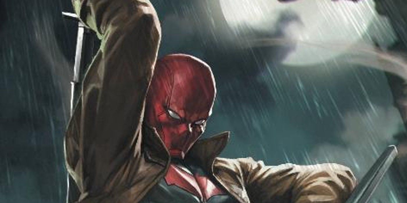Red Hood standing in the rain in the DC Comics