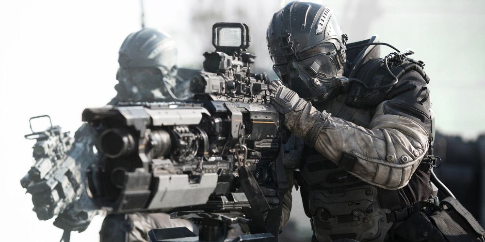 Heavily armed soldiers aim a large gun in Spectral