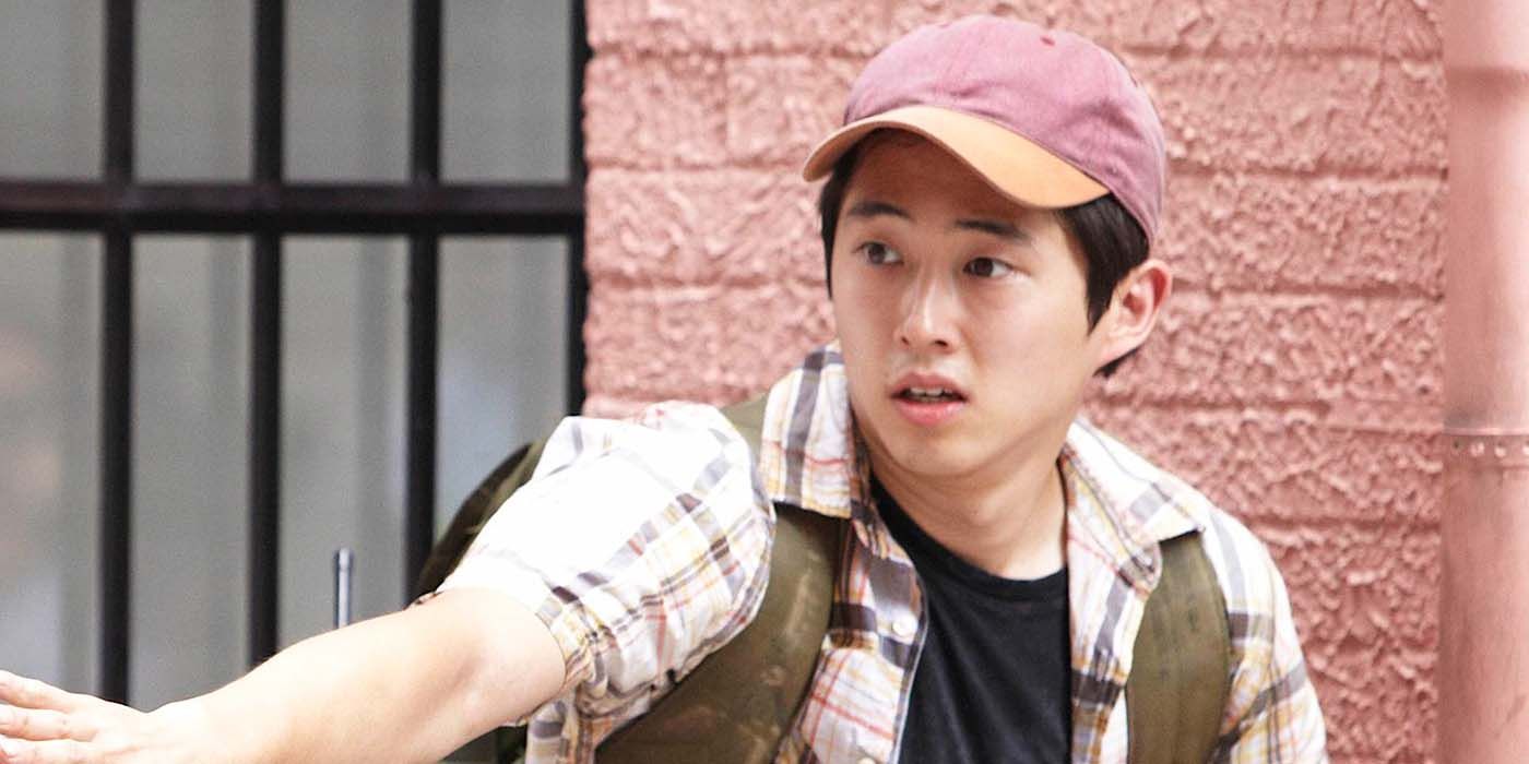 Glenn from season 1 of The Walking Dead, wearing a baseball hat and backpack.