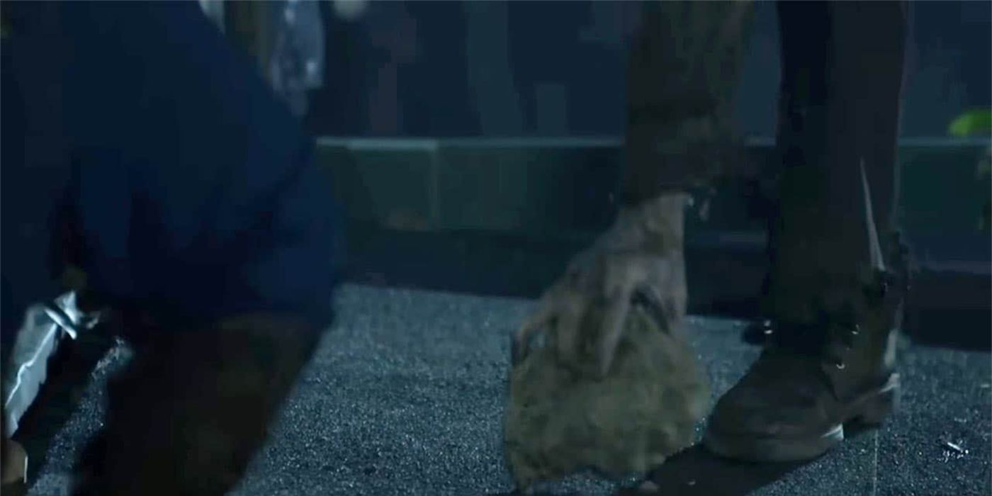 A walker's hand grasping a rock on The Walking Dead