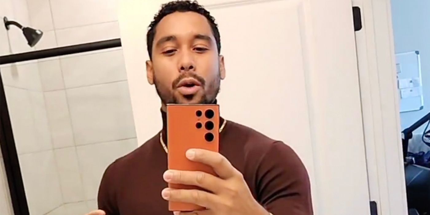 Pedro Jimeno from The Family Chantel holding phone wearing brown shirt