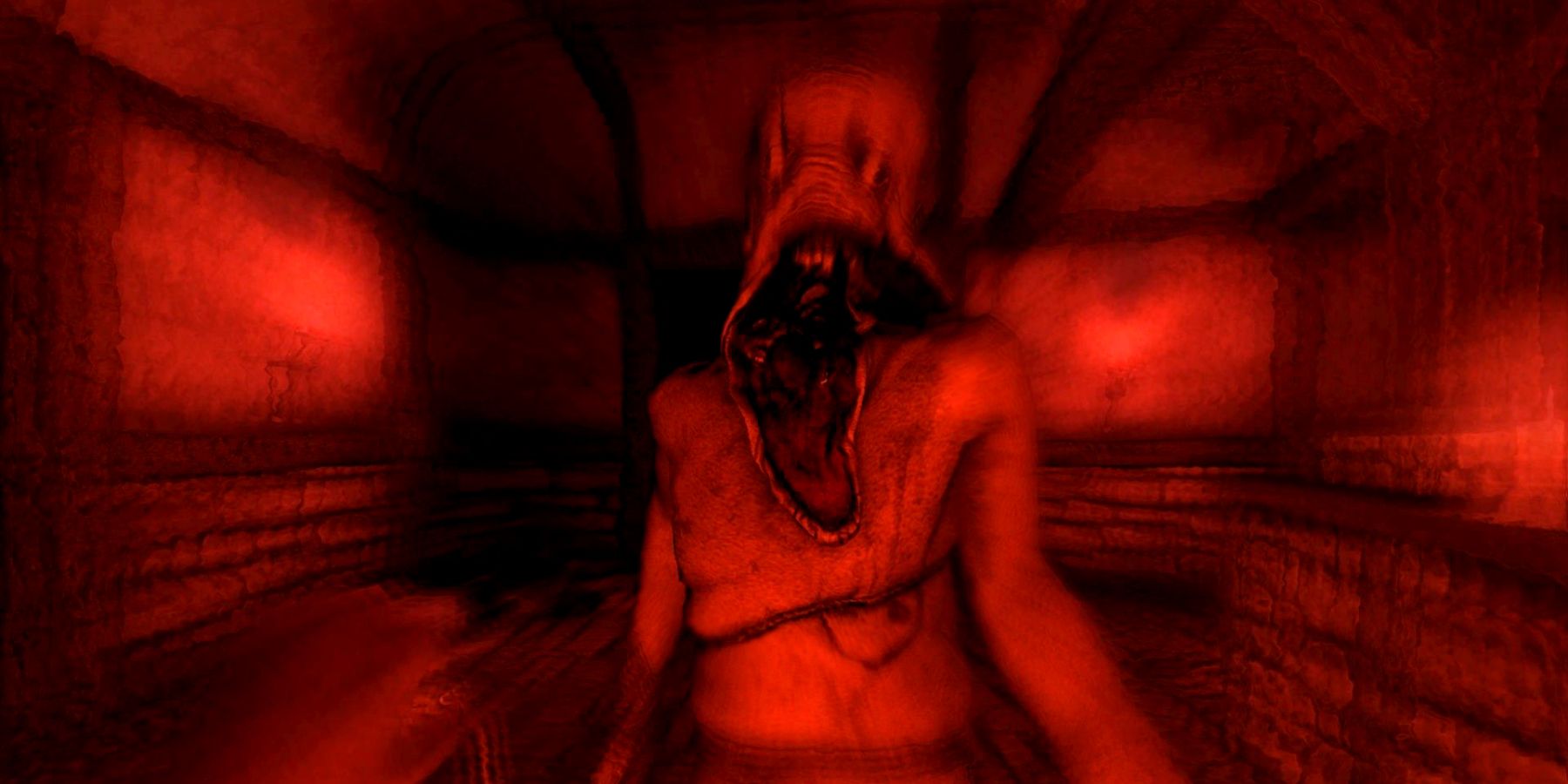 The player in Amnesia: The Dark Descent facing a monster with a low sanity stat, making the screen turn bright red.