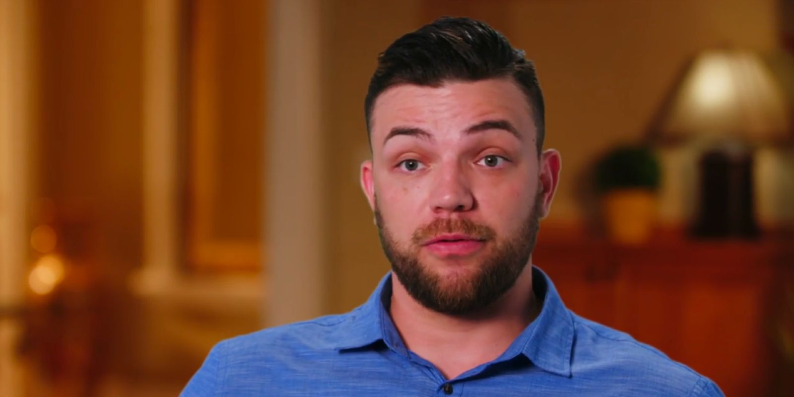 Andrei Castravet from 90 Day Fiancé wearing blue shirt looking serious