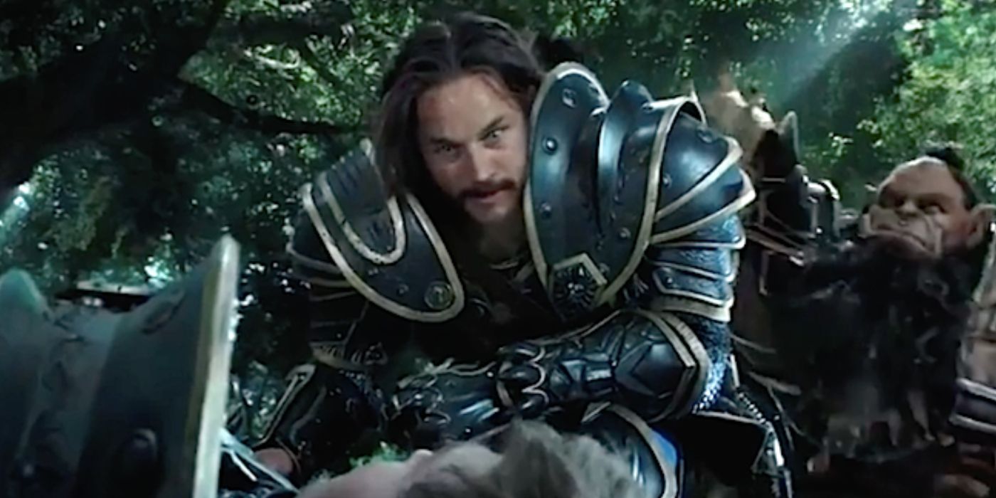 Anduin kneeling over someone in his armor looking excited in Warcraft. 