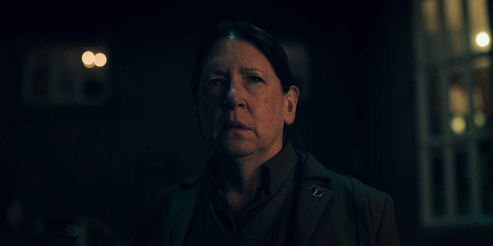 Aunt Lydia (Ann Dowd) looking sad and serious in The Handmaid's Tale.