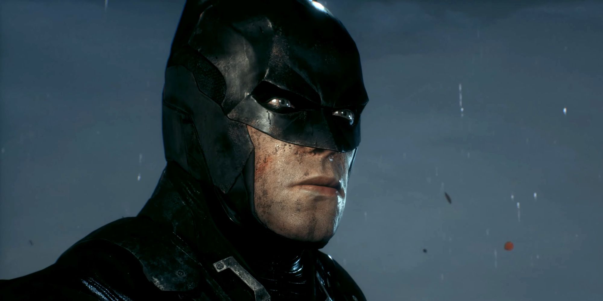 Batman vers la fin d'Arkham Knight, avec un costume endommagé et de la saleté sur le visage.