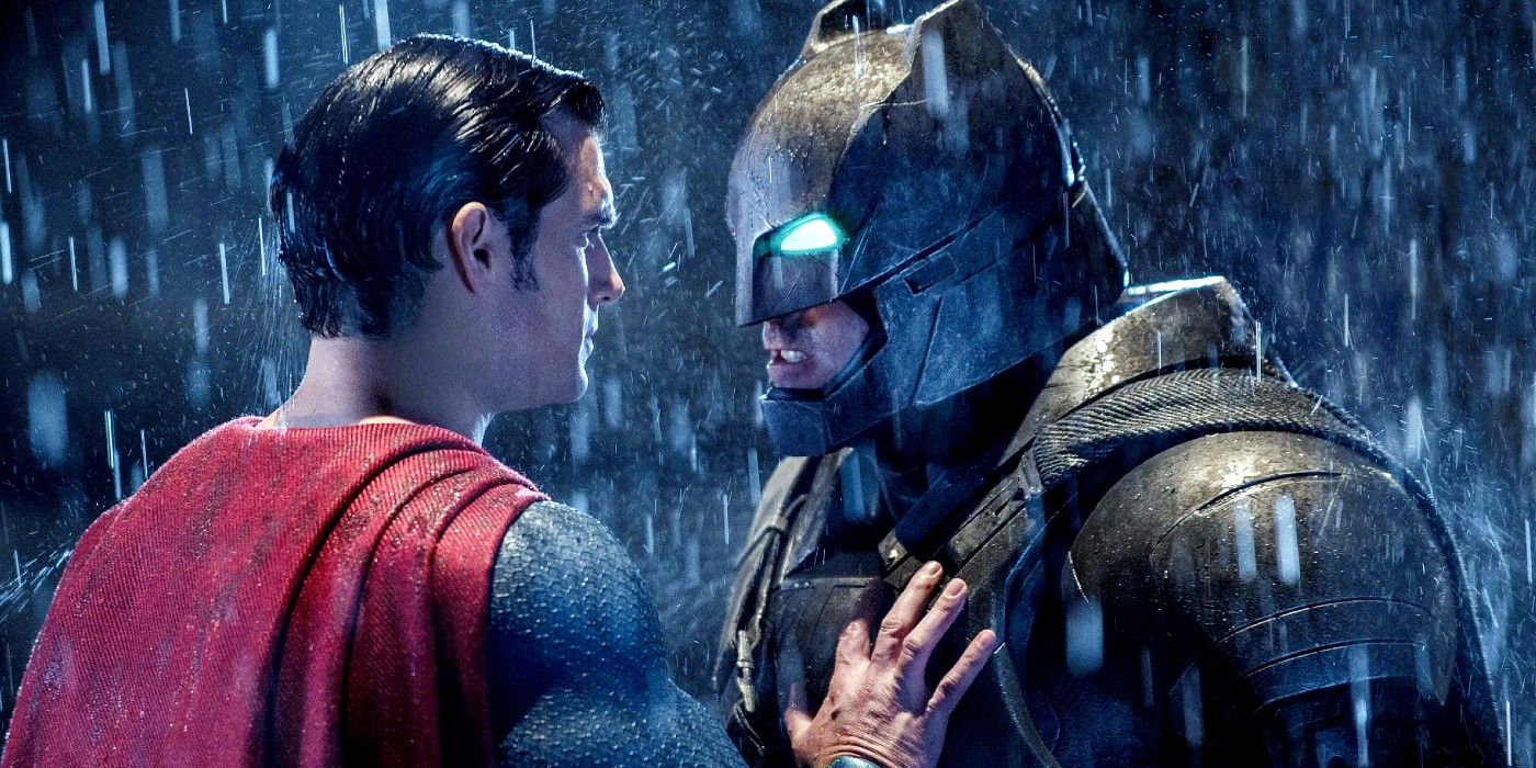 Batman stares Superman in the eyes while wearing his armored suit.