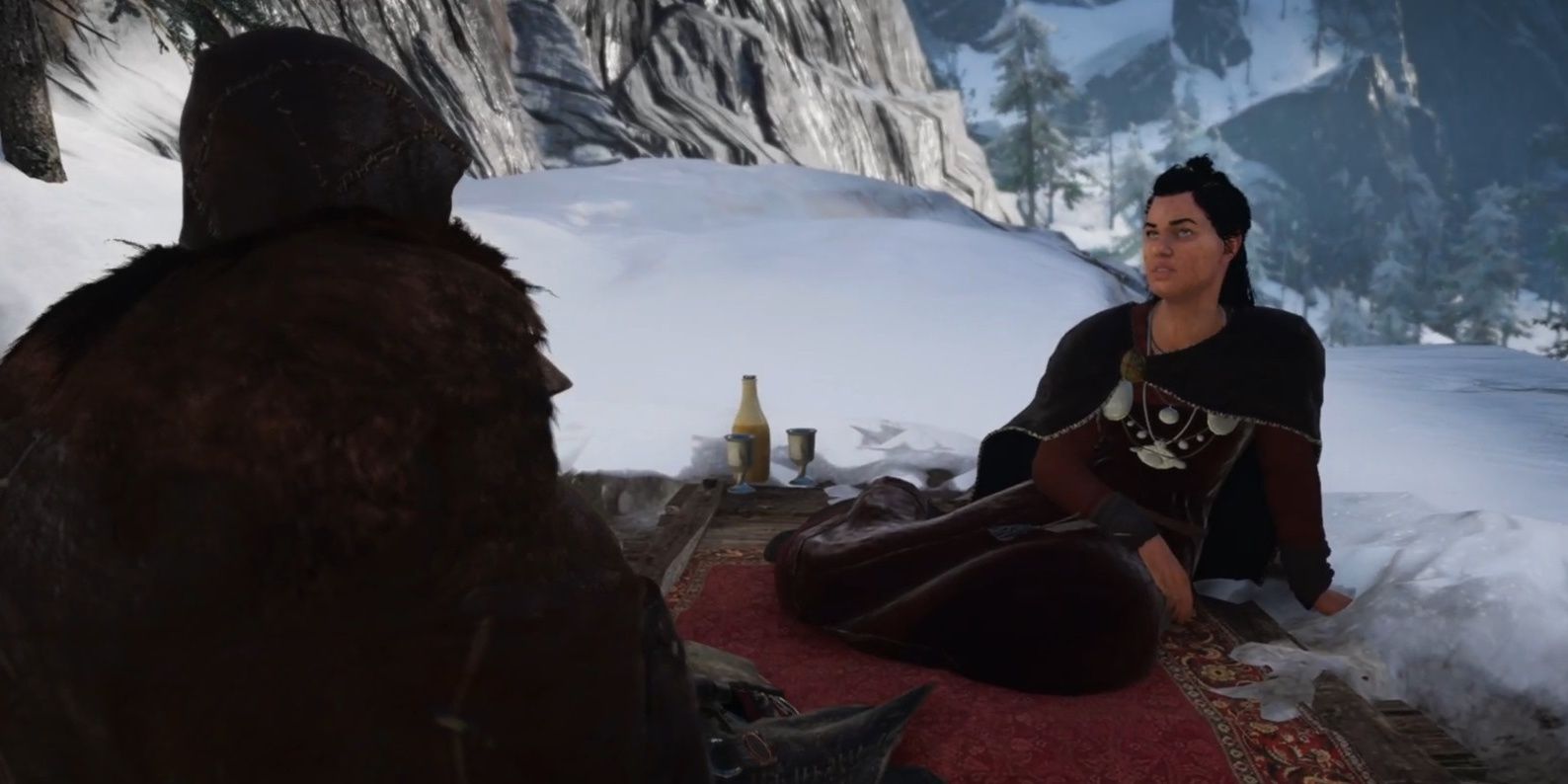 Bil sitting on a carpet in a snowy setting in Assassin's Creed Valhalla.
