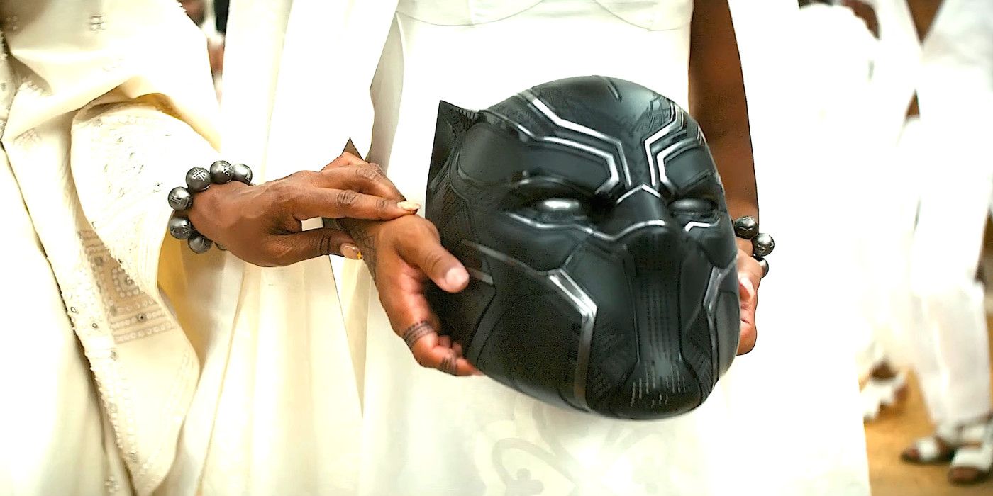 A character in a white ceremonial costume carries the iconic Black Panther mask.