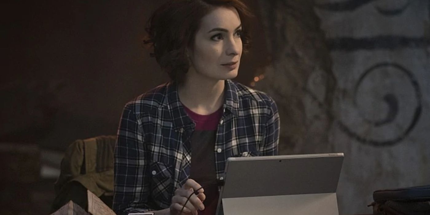 Charlie sitting in front of a computer in Supernatural. 