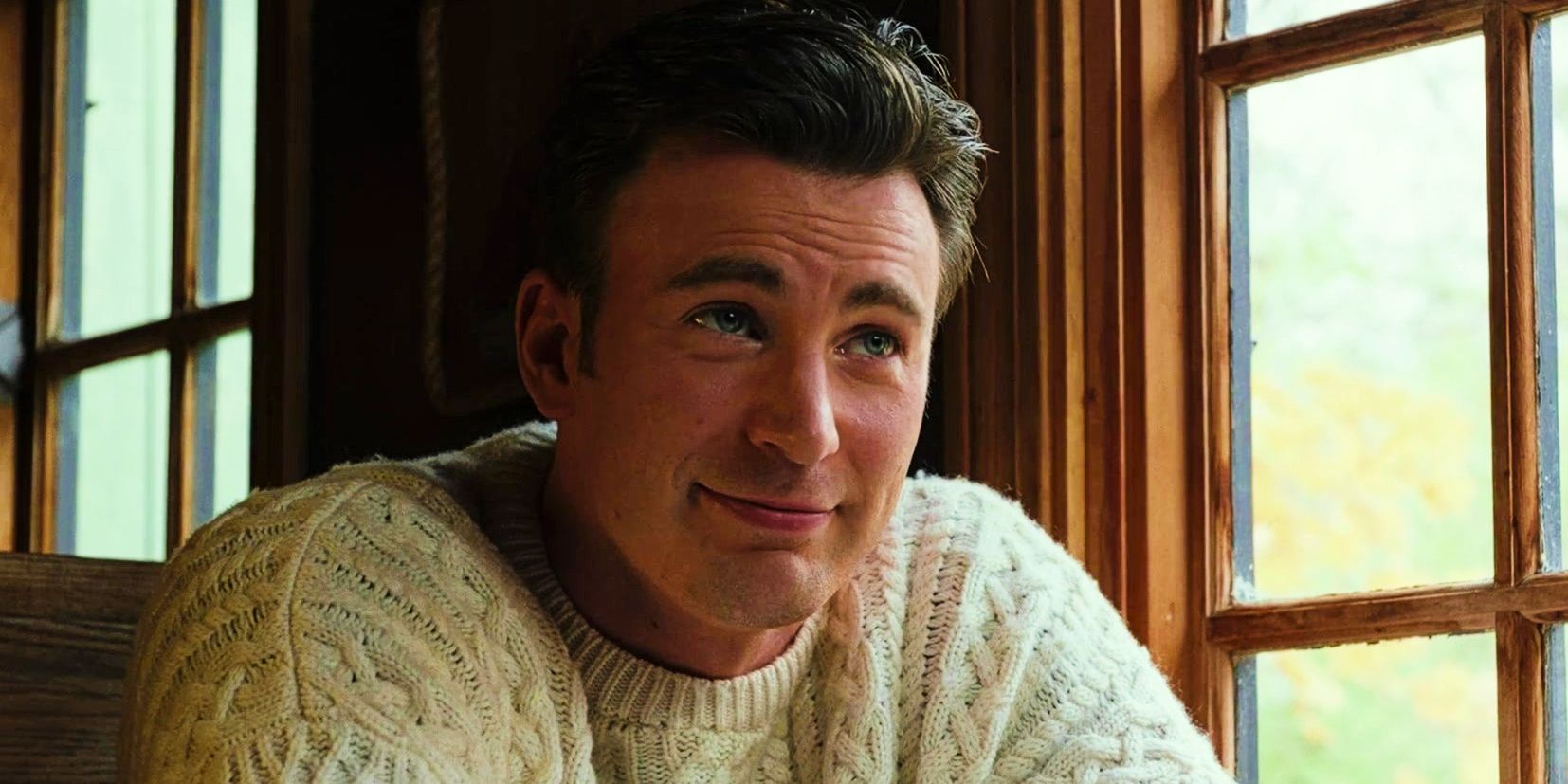 Chris Evans as Ransom smiling at Marta in Knives Out in sweater