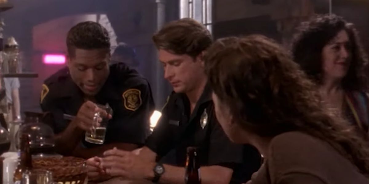 Christopher Judge sharing a drink with friends as Officer Richard Stiles in Sirens 1993