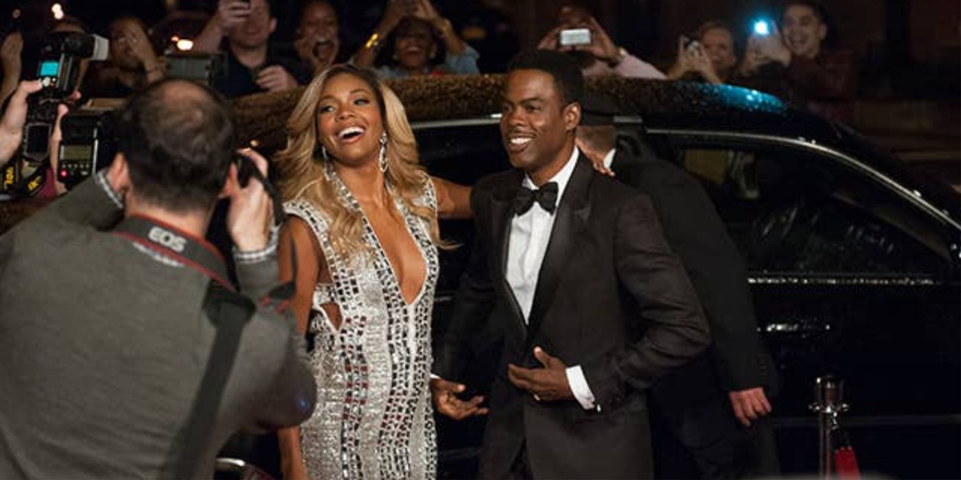 Gabrielle Union and Chris Rock posing for paparazzi in Top Five. 