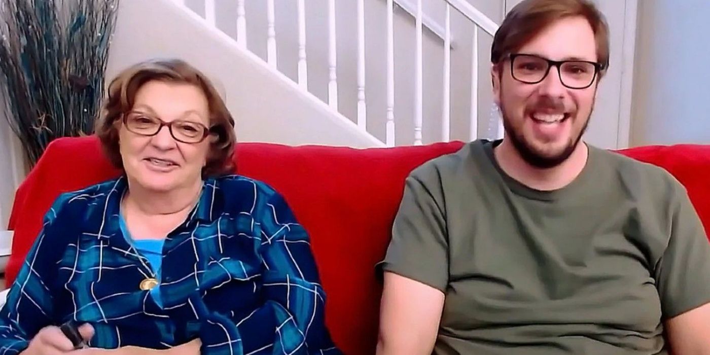 Colt and Debbie Johnson from 90 Day Fiancé sitting on couch smiling 