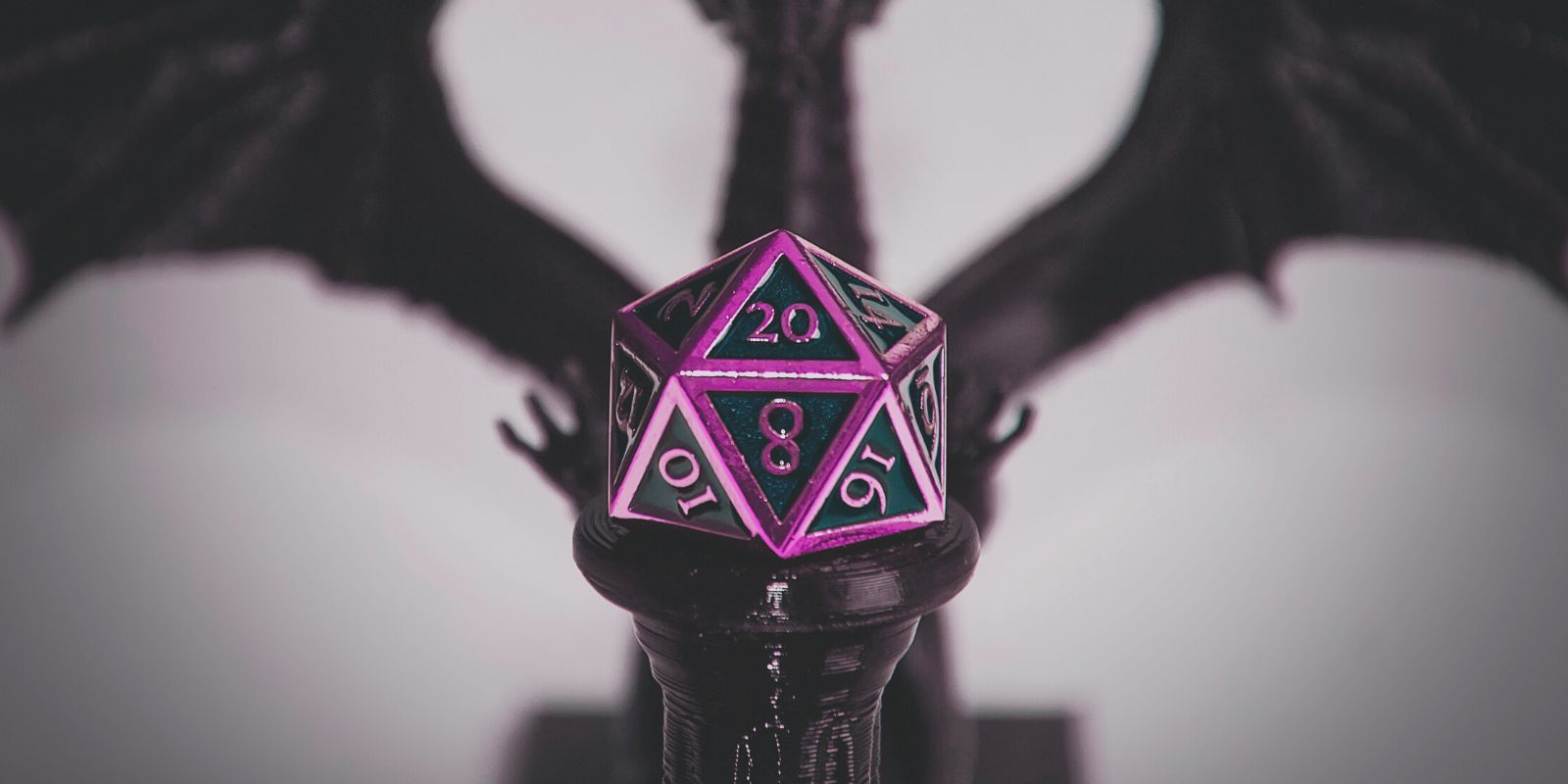 A purple metal 20 sided die on a pedestal with a blurred out dragon in the background