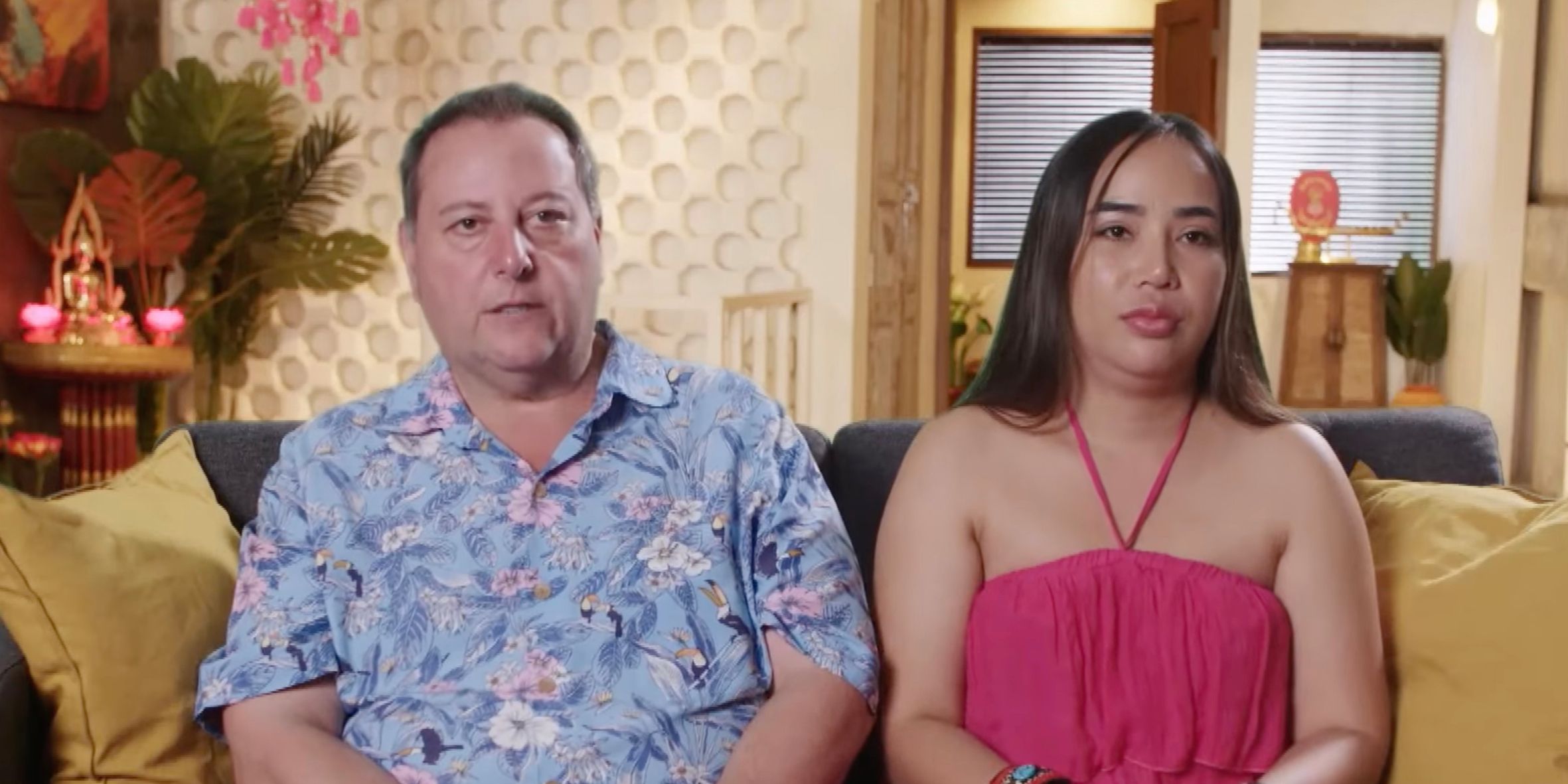 David & Annie Toborowsky from 90 Day Fiance cast members on couch with serious expressions