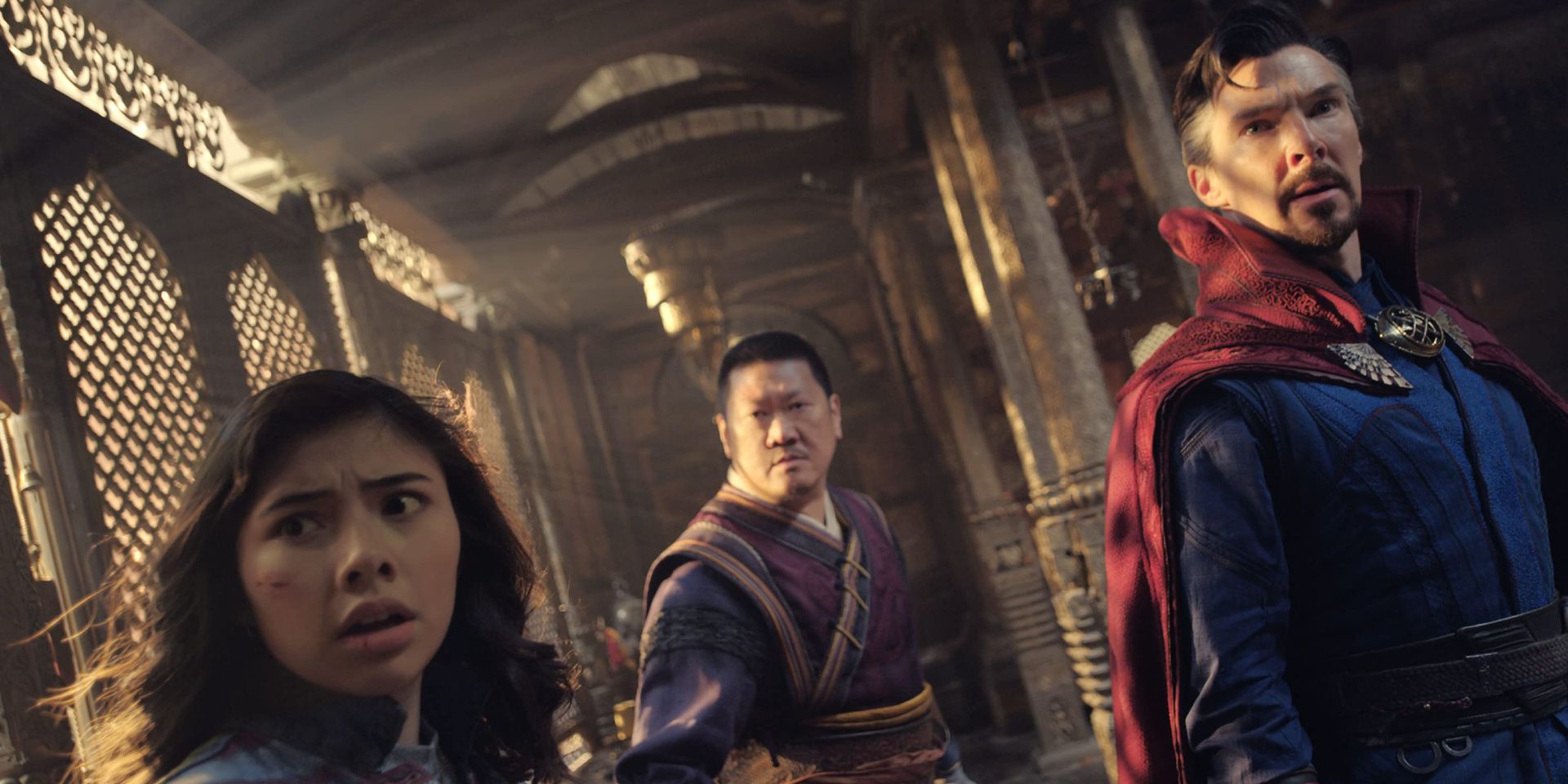 Doctor Strange (Benedict Cumberbatch), Wong (Benedict Wong), and America Chavez (Xochitl Gomez) running from Scarlet Witch in Doctor Strange in the Multiverse of Madness