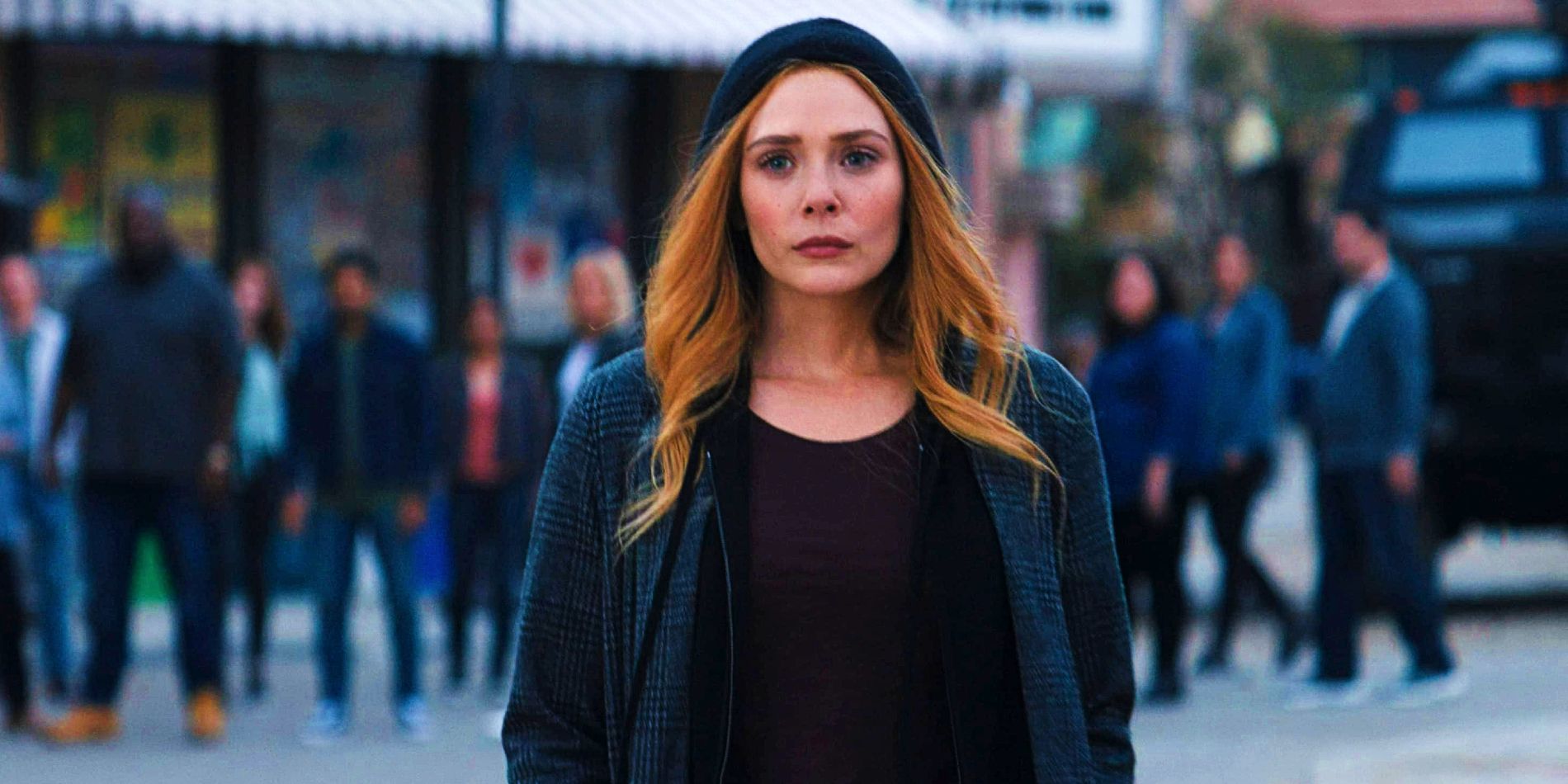 Elizabeth Olsen as Wanda Maximoff Scarlet Witch standing in Westview street at the end of WandaVision