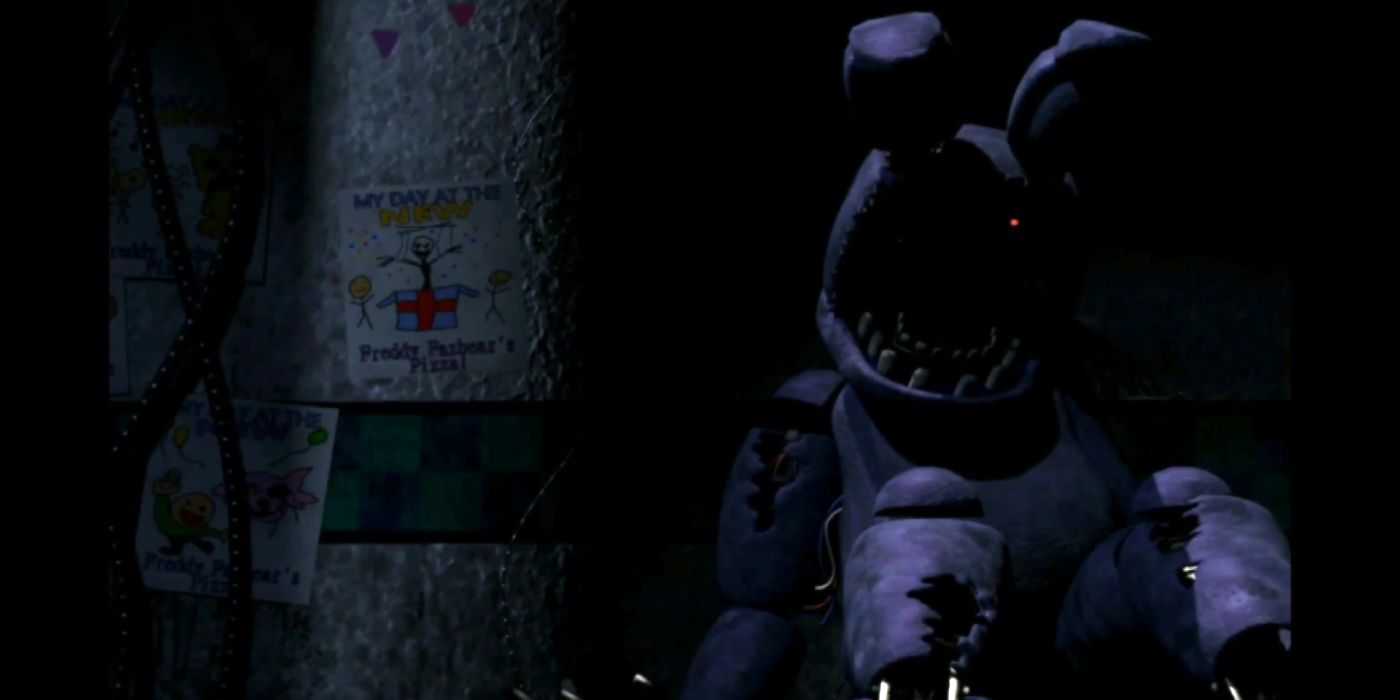 Withered Bonnie, from Five Nights At Freddy's 2, sitting on the floor of the pizzeria, with one of its eyes glowing red.