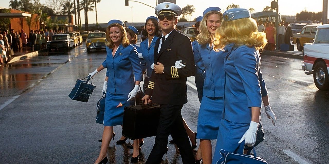 Frank dressed up as a pilot with flight attendants in Catch Me If You Seen