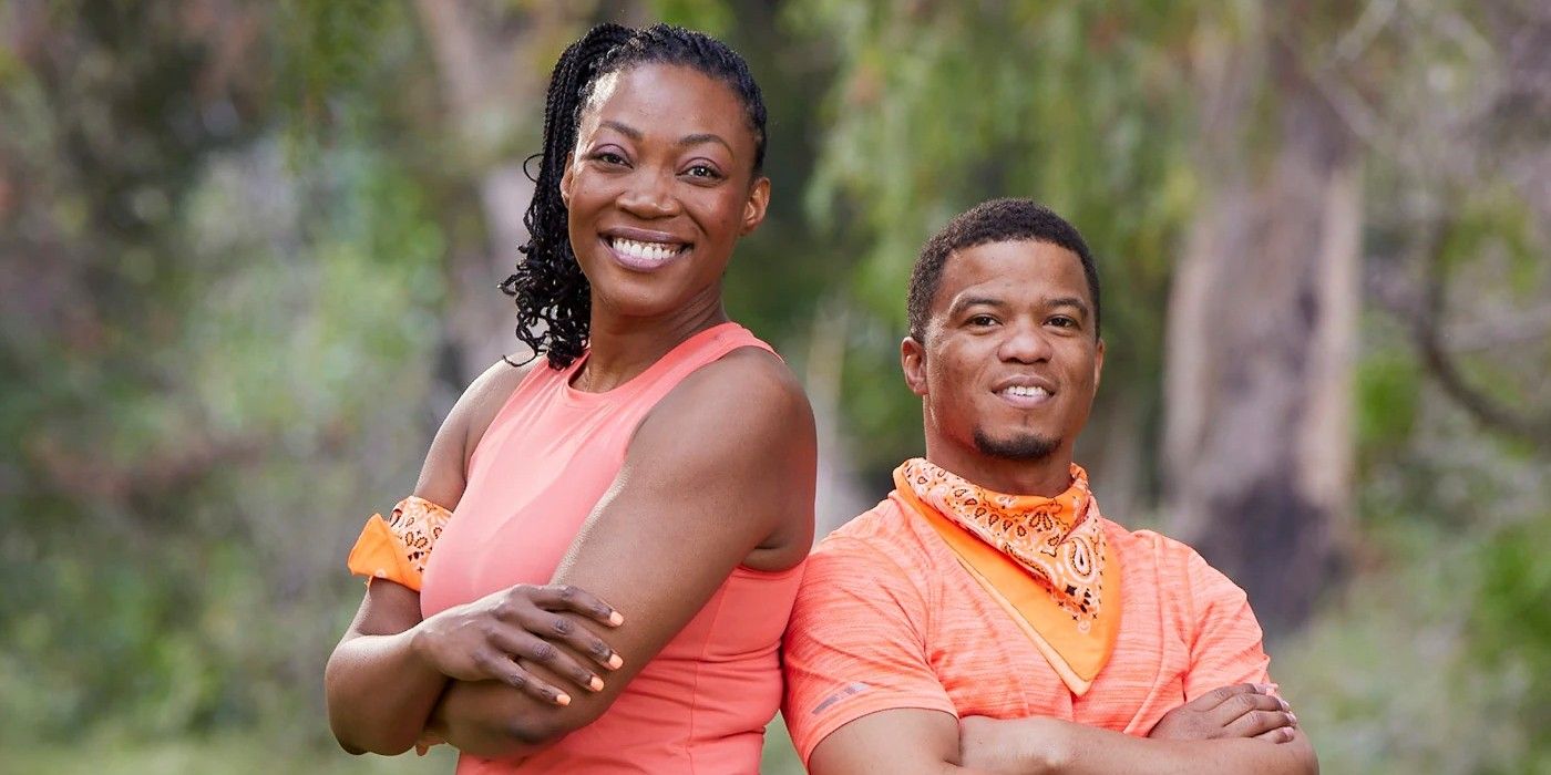 Glenda and Lumumba Roberts on The Amazing Race 34 smiling in their orange team gear.