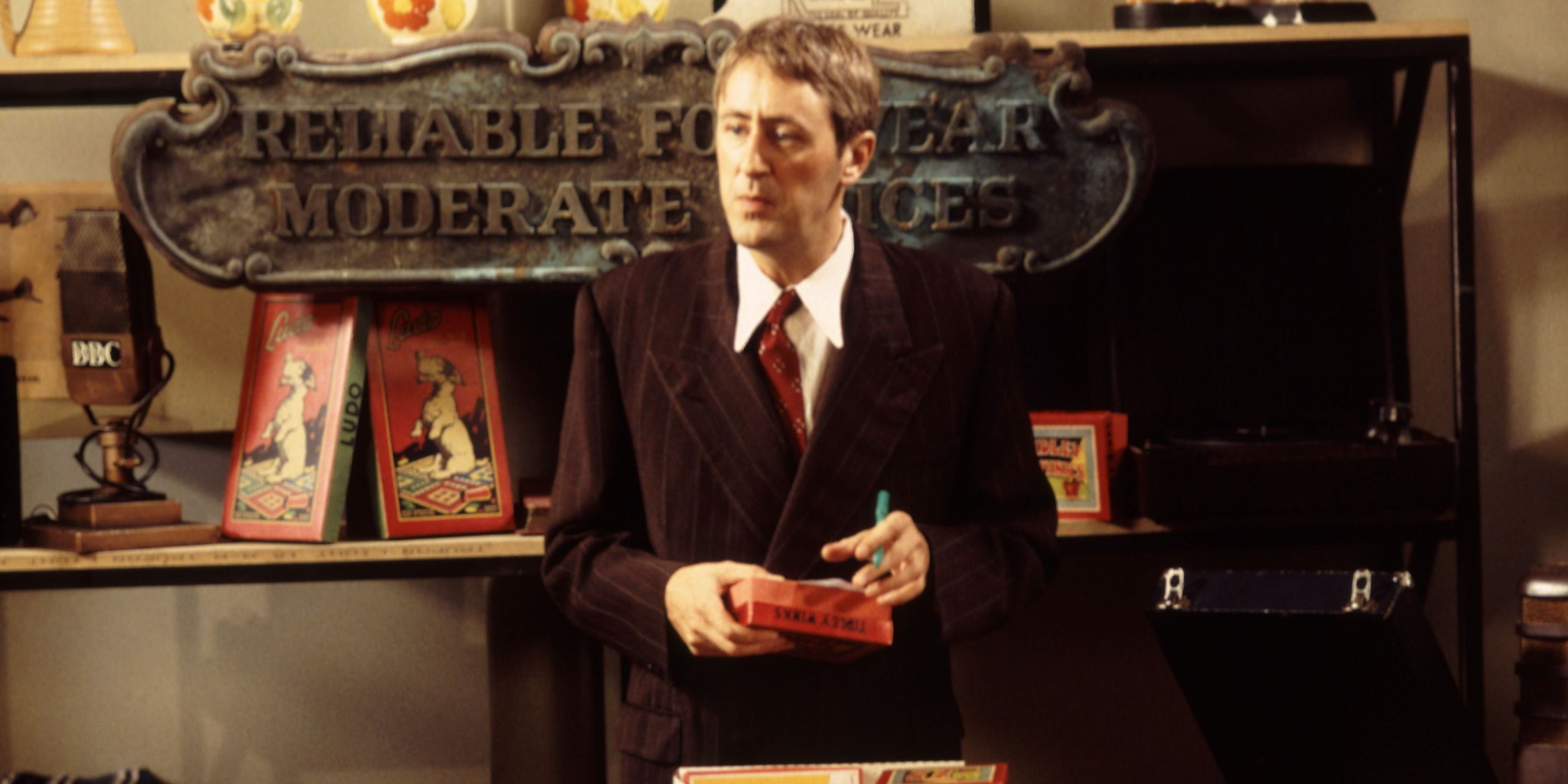 Gary Sparrow stands behind the counter in his wartime antiques shop in Goodnight Sweetheart.