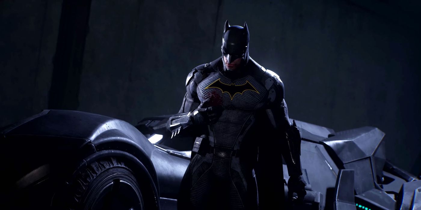 Batman em Gotham Knights parado em frente ao Batmóvel