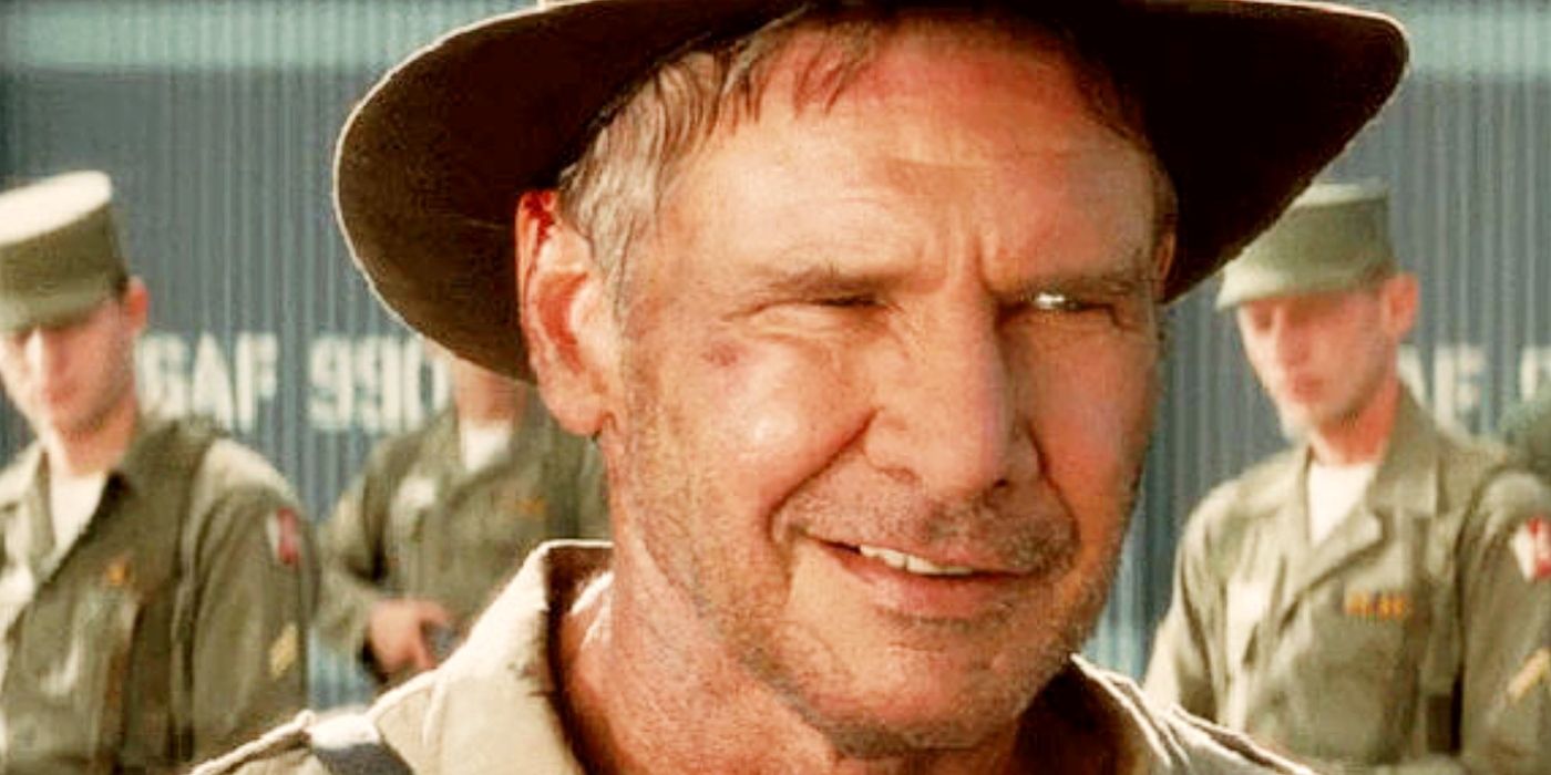 Harrison Ford as Indiana Jones smiles in front of the Soviet soldiers.
