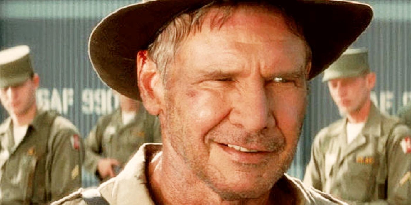 Harrison Ford smiling as Indiana Jones in front of Soviet soldiers.