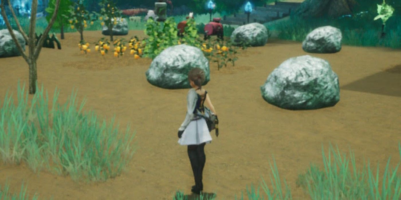 Harvestella protagonist and big rocks scattered on a farm.
