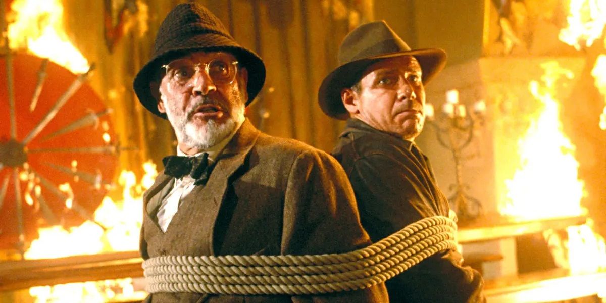Indy en zijn vader vastgebonden in een brandende kamer in Indiana Jones and the Last Crusade