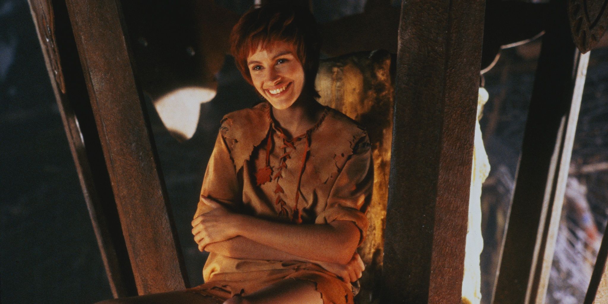 Julia Roberts as Tinkerbell smiling in a lamp in Hook