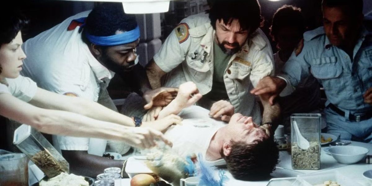 Kane collapses on the table in Alien