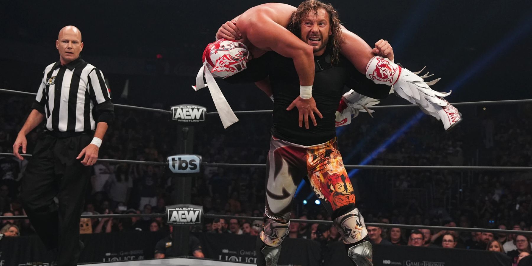 Kenny Omega hoists Rey Fenix onto his shoulders during a match on AEW Dynamite.