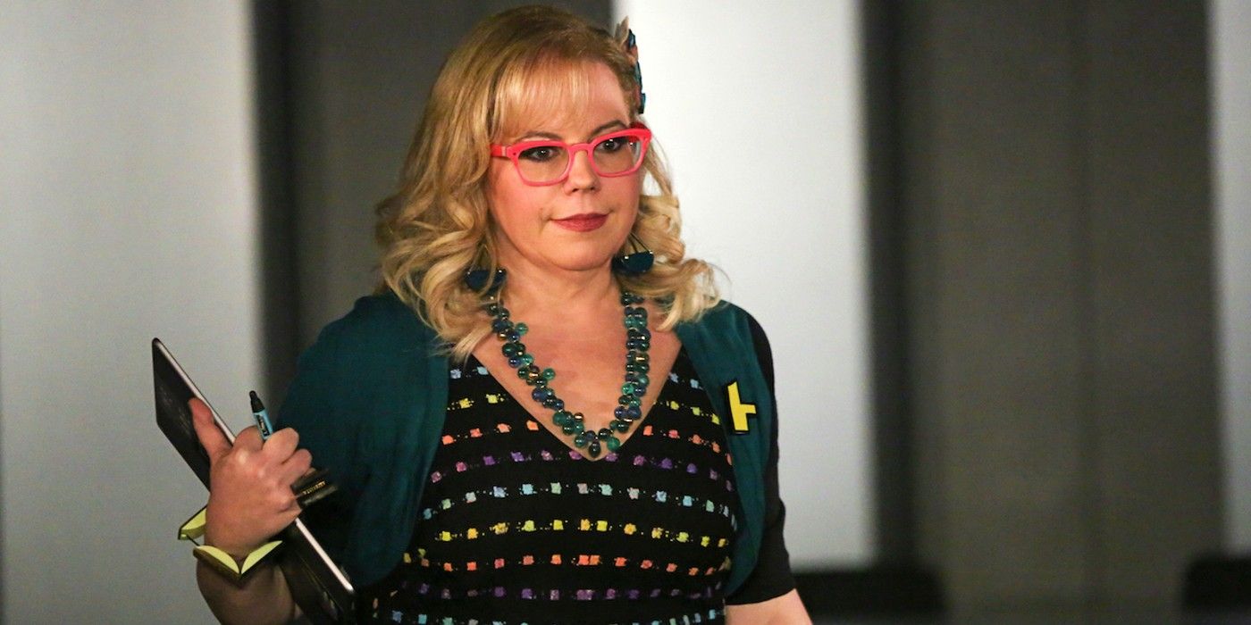 Kirsten Vangsness as Penelope Garcia smiling and holding a clipboard in Criminal Minds