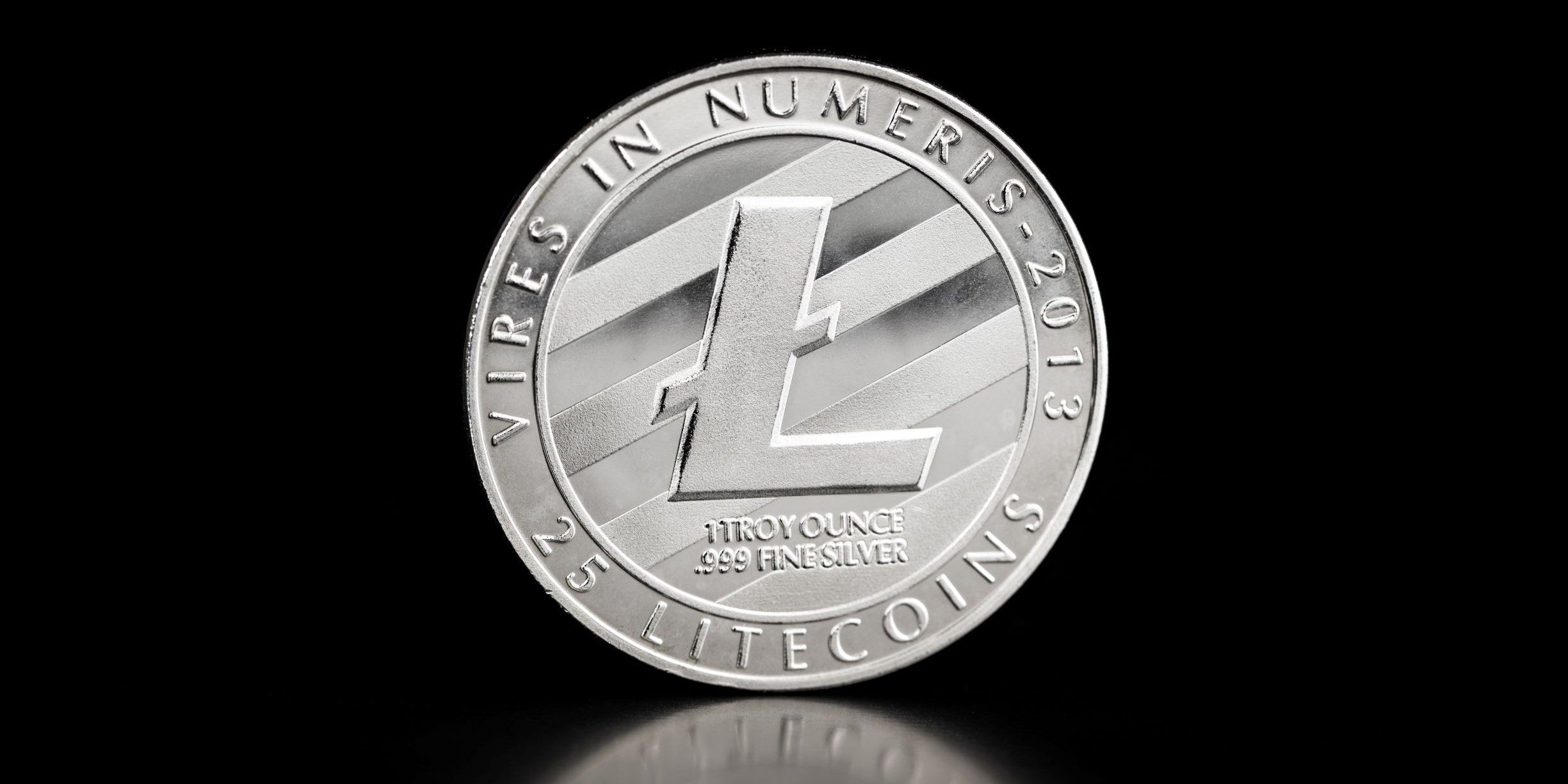 Silver coin with Litecoin logo on black background