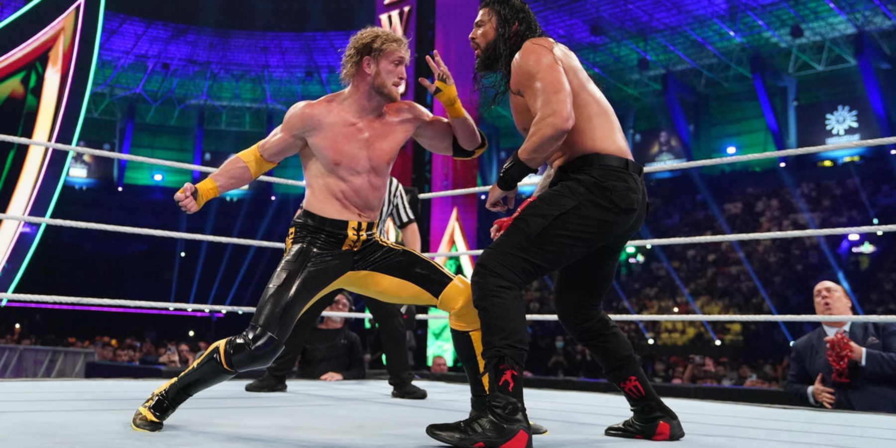 Logan Paul winds up to punch Roman Reigns during their match at WWE Crown Jewel.
