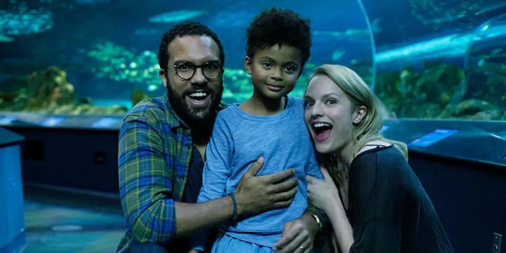 Luke, Hannah, and June laughing and smiling at the aquarium in The Handmaid's Tale