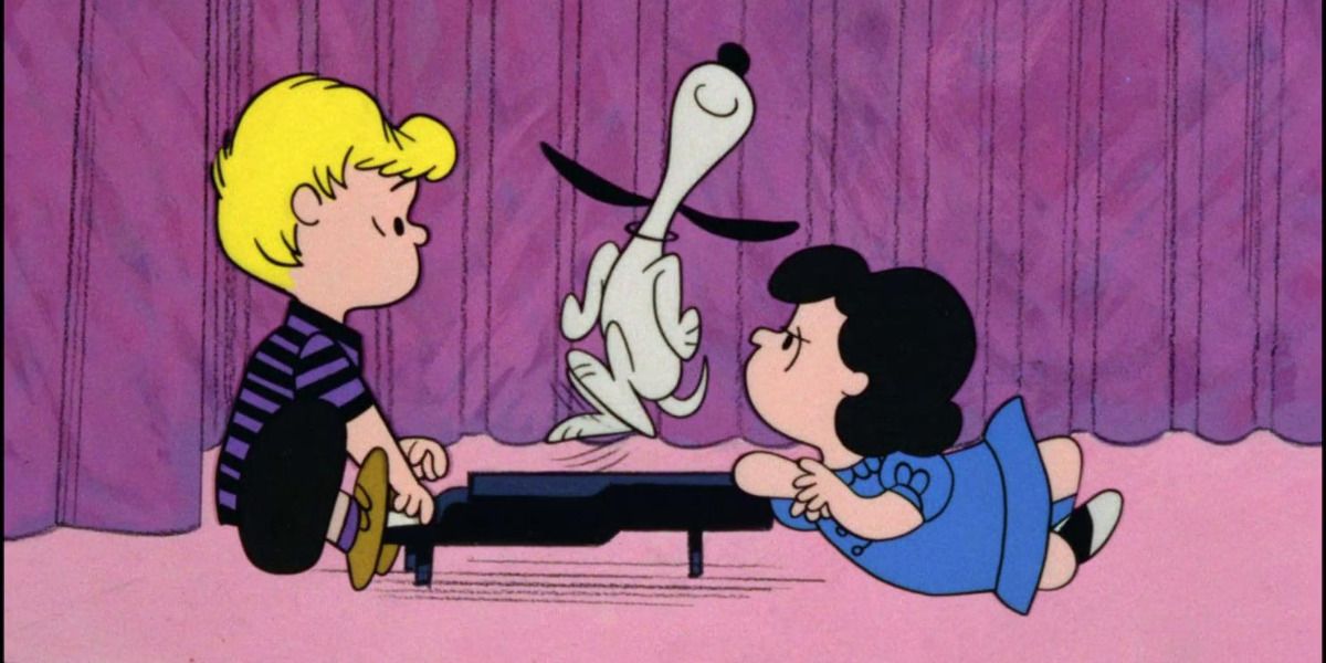 An image of Snoopy dancing on Schroeder&rsquo;s piano while Lucy frowns is shown.
