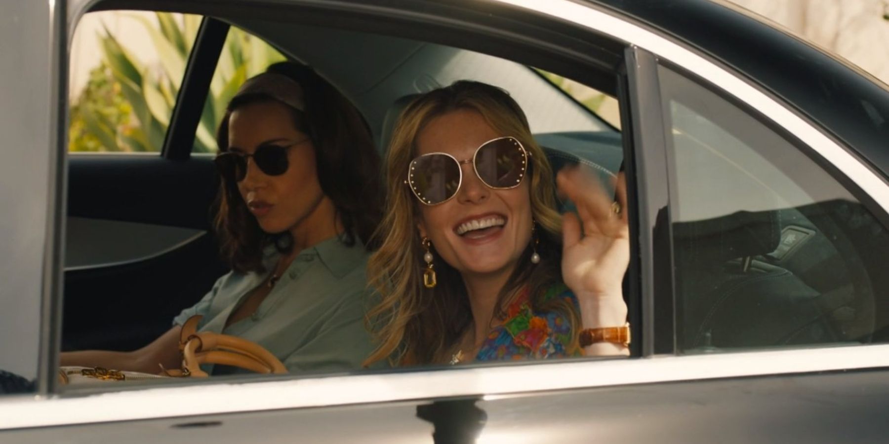 Meghann Fahy as Daphne Sullivan waving from her taxi in The White Lotus