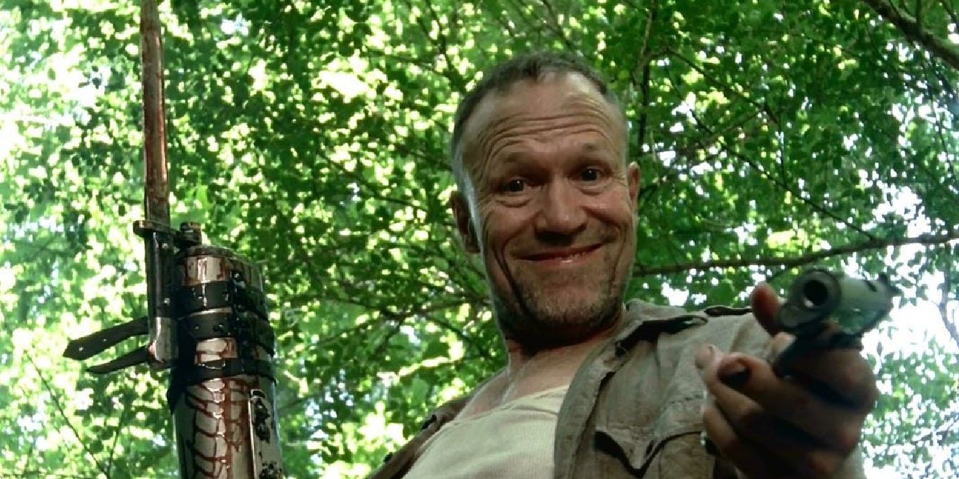 TWD: Michael Rooker as Merle pointing a gun at the camera