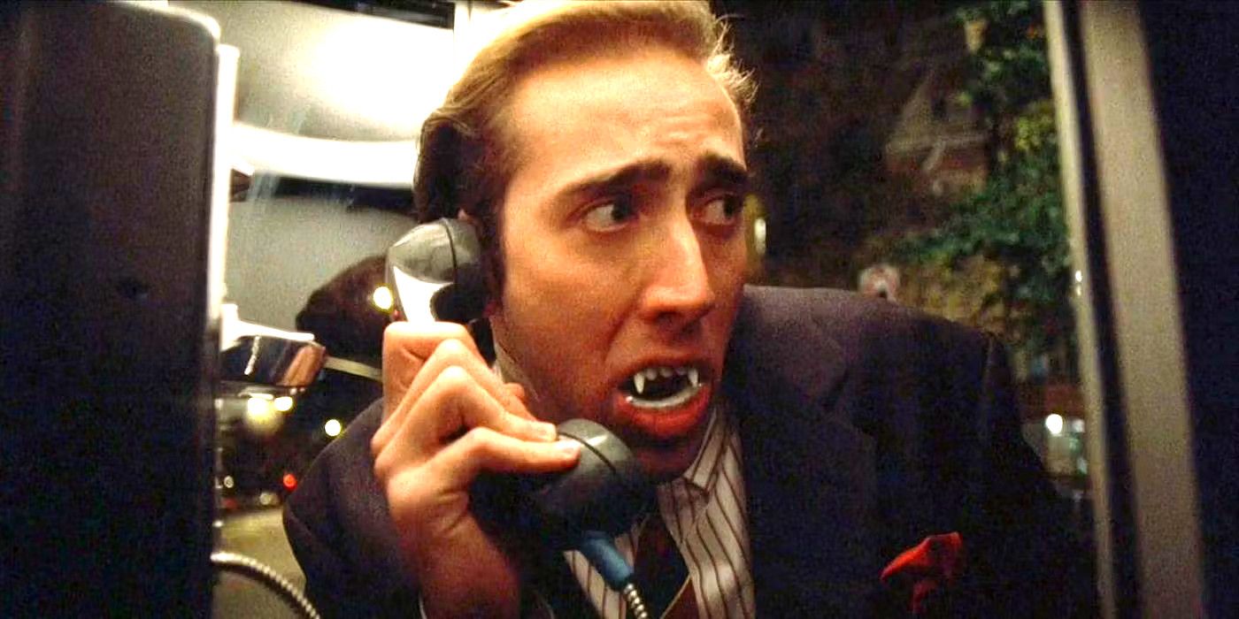 Nicolas Cage in Vampire's Kiss in a phone booth with comically huge vampire teeth