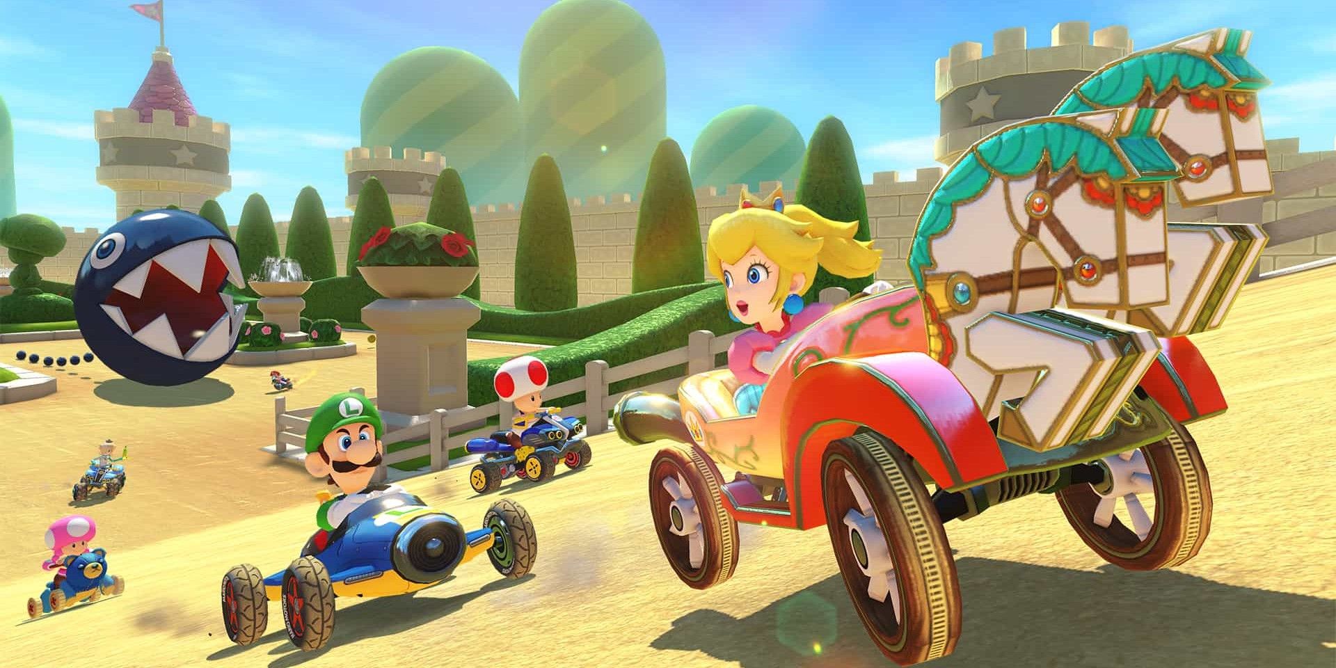 Peach Garden Mario Kart 8 race with Peach in front and Luigi, Toad, Toadette, and a Chain Chomp behind her.